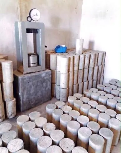 Concrete test cubes beside a compression testing machine