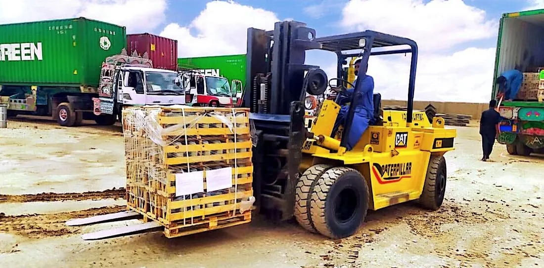 Forklift unloading insulator crates from containers