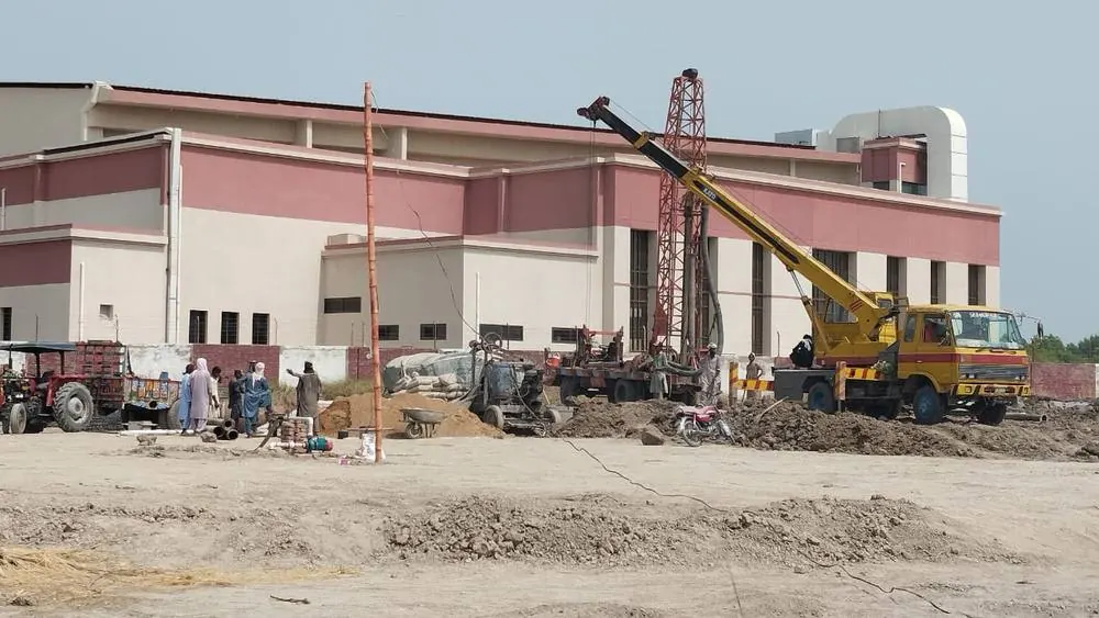 Piling rig and crane working in front of the grid station building