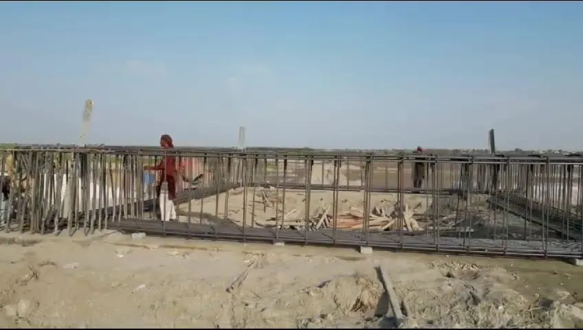 Worker fixing reinforcement on a pile cap